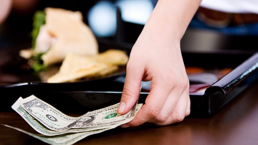 20151203195418-coffee-shop-server-picking-up-cash-tip-tipping-gratuity-money-customer